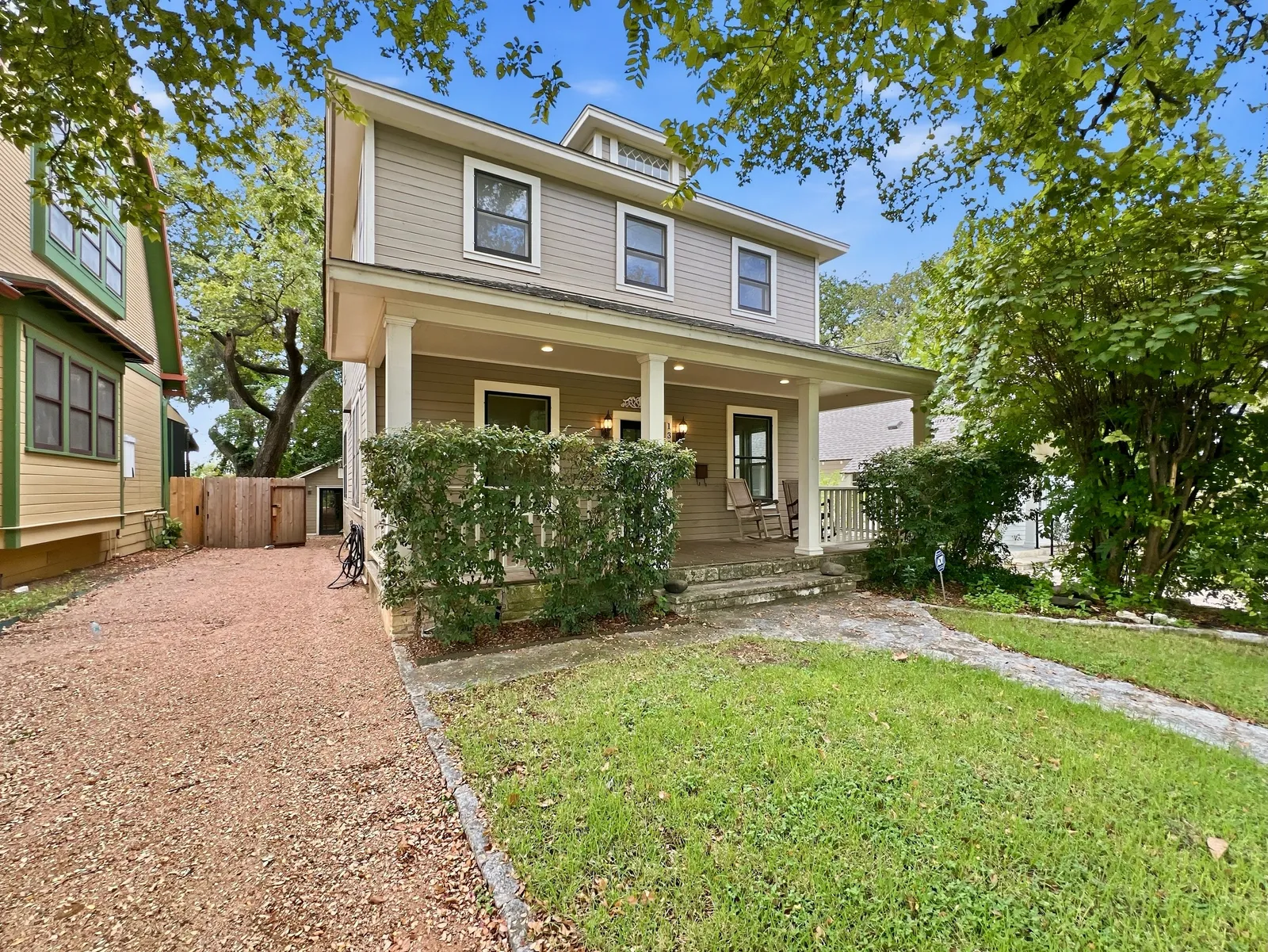 Two-story craftsman home on a leafy Austin street